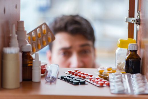 image of adult guy checking his medicines