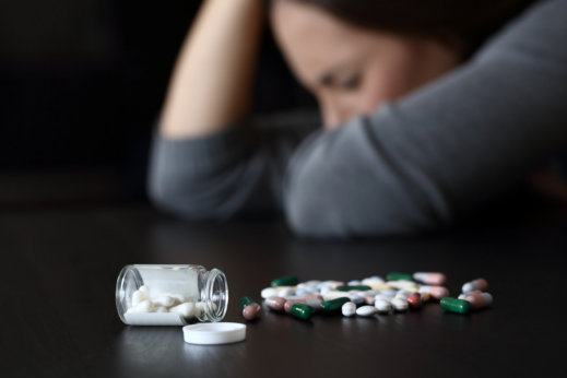 image of adult lady lying in the table with her medicines
