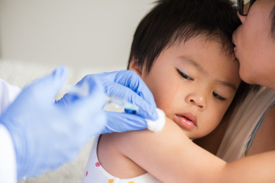 kid having a vaccine