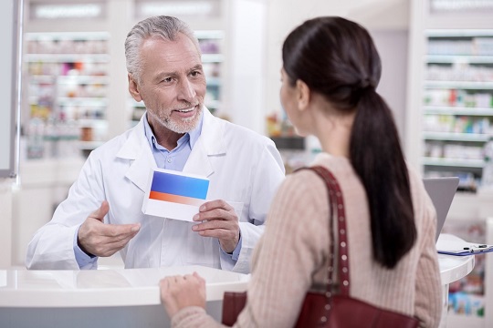 medical staff showing medicine to a woman