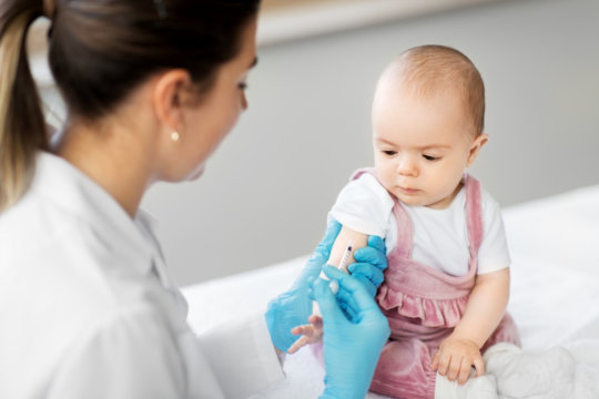 image of a baby having vaccinated